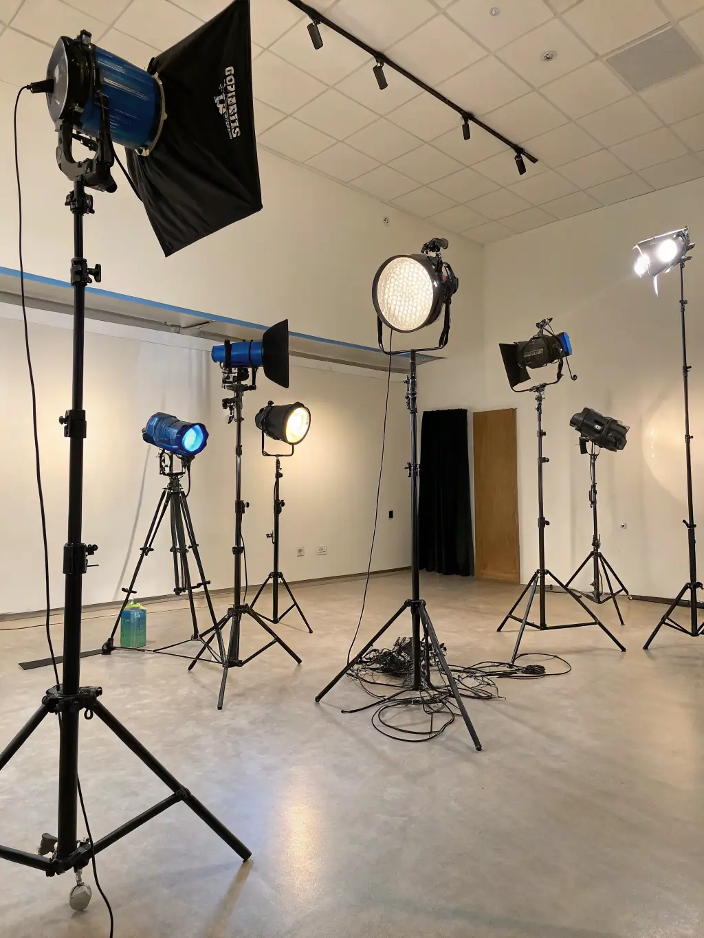 A variety of professional lighting equipment set up on a film set, demonstrating the use of advanced lighting techniques to create cinematic visuals.